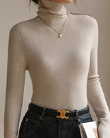 Close-up of the roll neck and shoulder area of the knit top