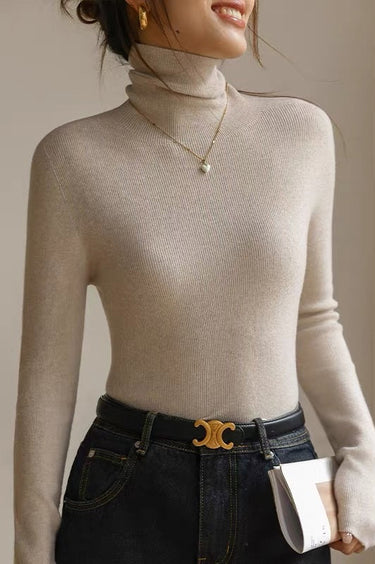 Close-up of the roll neck and shoulder area of the knit top