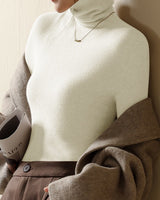 Front view of a ribbed roll neck knit top in a slim fit