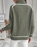 Model wearing the green roll neck sweater styled with trousers