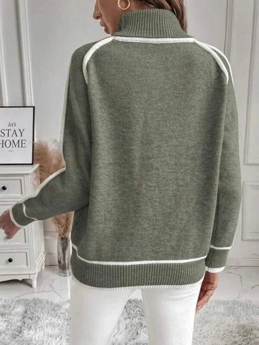 Model wearing the green roll neck sweater styled with trousers