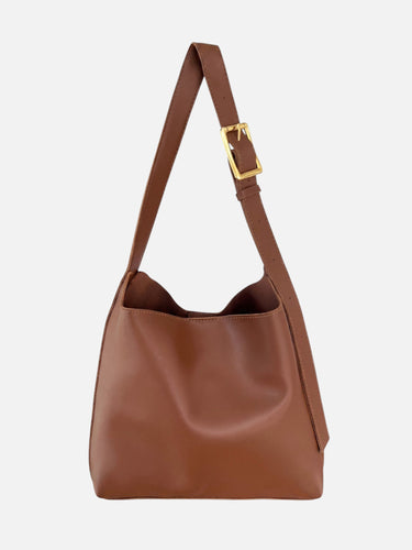 Side profile of the hobo bag showing the curved silhouette and strap attachment