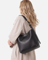 Close-up of the gold-toned buckle and exterior finish of the hobo bag