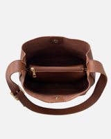 Model carrying the bag crossbody, showing the adjustable strap at full length