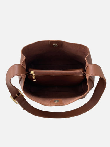 Model carrying the bag crossbody, showing the adjustable strap at full length