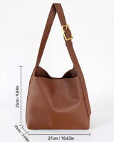 Flat lay of the hobo bag next to everyday essentials such as a phone and wallet