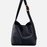 Front view of a rounded hobo bag with a gold-toned buckle and adjustable shoulder strap