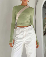 Close-up of the ruched sleeve and thumbhole cuff detail