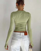 Side view showing the cropped length and fitted silhouette