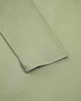 Close-up of the minimal neckline and ruched fabric texture