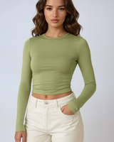 Front view of a ruched long sleeve crop top with thumbhole cuffs