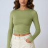 Front view of a ruched long sleeve crop top with thumbhole cuffs