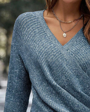 Side view showing the dropped shoulder silhouette and hem length of the jumper