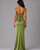 Side view showing the fluid floor-length skirt and gathered waist detail