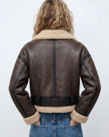 Close-up of the ribbed collar and zip detail on the shearling bomber jacket