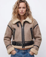 Side profile of the shearling bomber jacket showing cropped length and ribbed cuffs