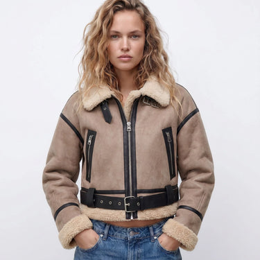 Side profile of the shearling bomber jacket showing cropped length and ribbed cuffs