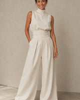 Side view of sleeveless wide-leg jumpsuit showing linen blend drape and waist detail