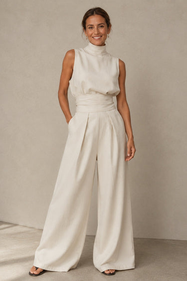 Side view of sleeveless wide-leg jumpsuit showing linen blend drape and waist detail