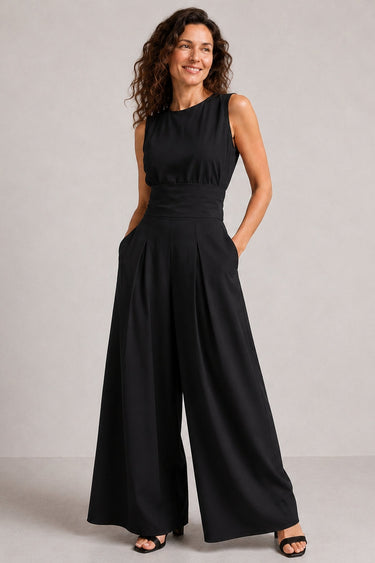 Model wearing sleeveless wide-leg jumpsuit in graphite, styled for a casual occasion