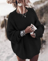 Side view showing the hip-length hem and relaxed silhouette of the chunky knit jumper