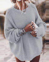 Front view of a slouchy oversized chunky knit jumper with dropped shoulders and wide sleeves