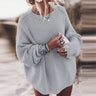 Front view of a slouchy oversized chunky knit jumper with dropped shoulders and wide sleeves