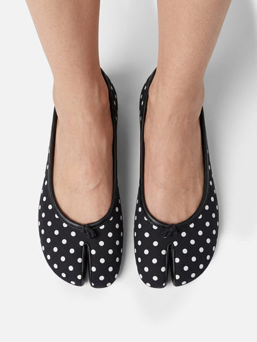 Top-down view of polka-dot print on ballet flat upper
