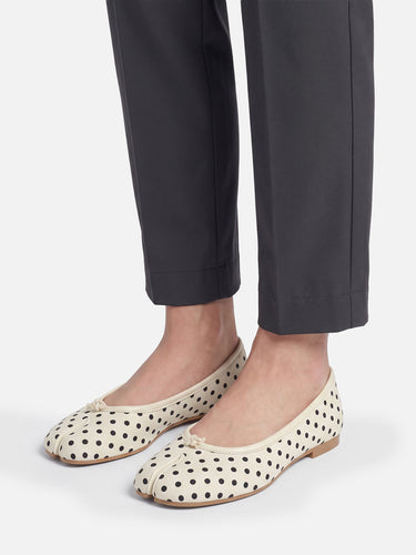 Ballet flat worn on foot showing split-toe and polka-dot print