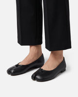 Top-down view of the knotted strap detail on the ballet flat