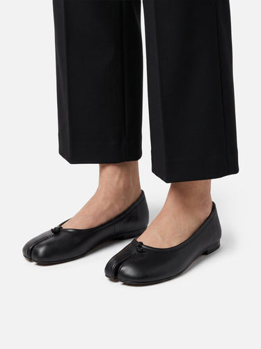 Top-down view of the knotted strap detail on the ballet flat