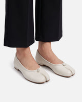 Pair of leather split-toe ballet flats on a plain background