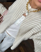 Close-up of stand collar detail on striped button-front cardigan