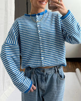 Side view showing hip length and long sleeves of striped cardigan