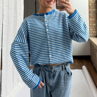 Side view showing hip length and long sleeves of striped cardigan