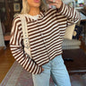 Front view of women's striped knit cardigan with stand collar and button front