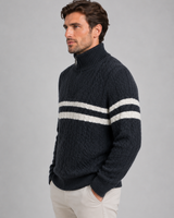 Full-length shot of the men's cable-knit jumper styled with trousers and boots