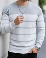 Men's striped jumper shown layered over a shirt, three-quarter view
