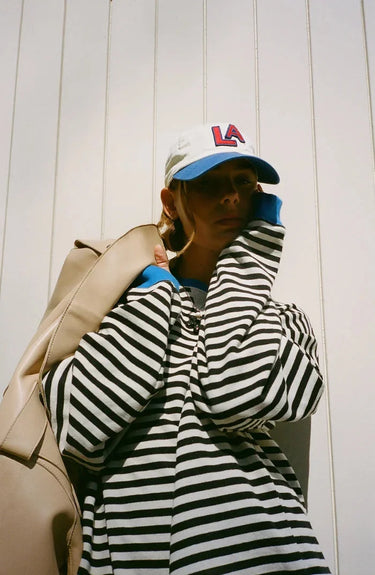 Full-length view of the striped jumper styled with jeans