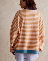 Model wearing the striped jumper with casual trousers
