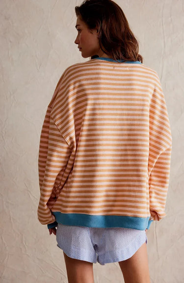 Model wearing the striped jumper with casual trousers