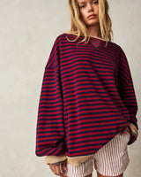 Model wearing the striped jumper in orange and blue