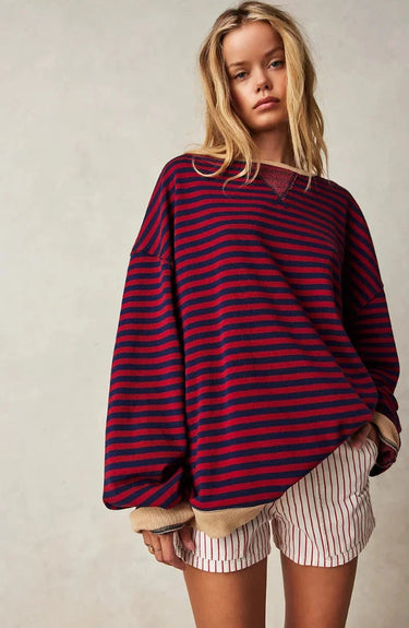 Model wearing the striped jumper in orange and blue
