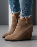 Close-up of the side cut-out detail on the outer shaft of the suede ankle boot