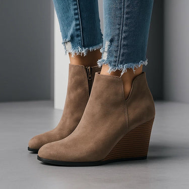 Close-up of the side cut-out detail on the outer shaft of the suede ankle boot