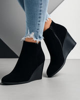 Suede ankle boots styled with tailored trousers, showing full silhouette