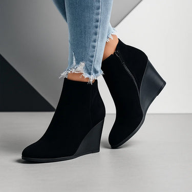 Suede ankle boots styled with tailored trousers, showing full silhouette