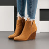Suede ankle boots with stacked wedge heel and side cut-out at topline, front view