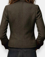 Close-up of flap chest pockets on a structured quilted tweed jacket