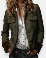 Front view of a quilted herringbone tweed jacket with gold buttons and velvet cuffs